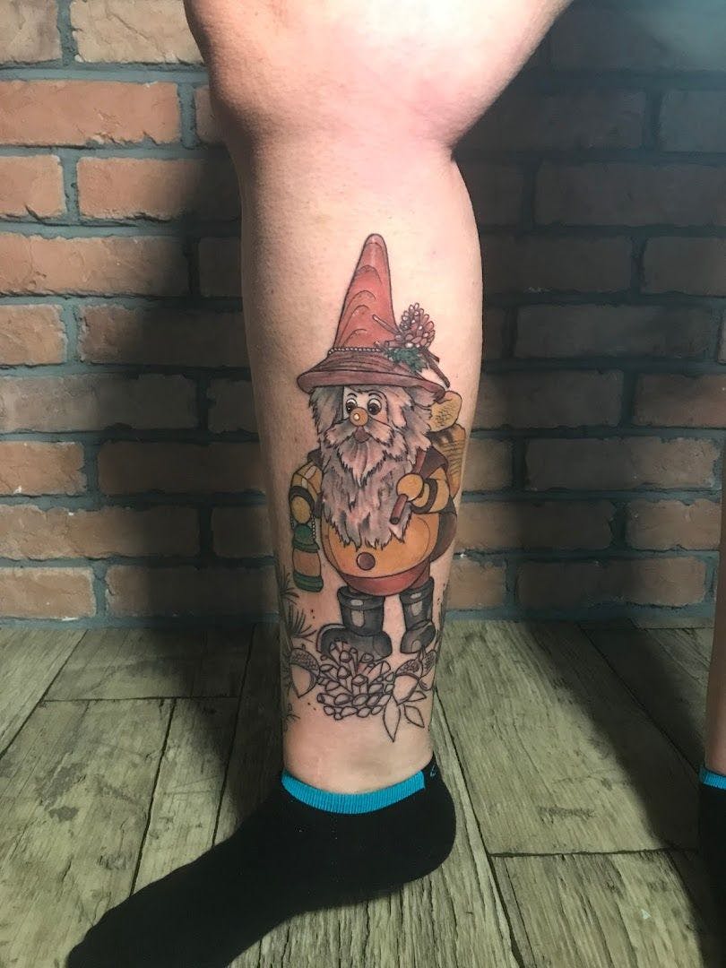 a cover-up tattoo of a gnome with a guitar, viersen, germany