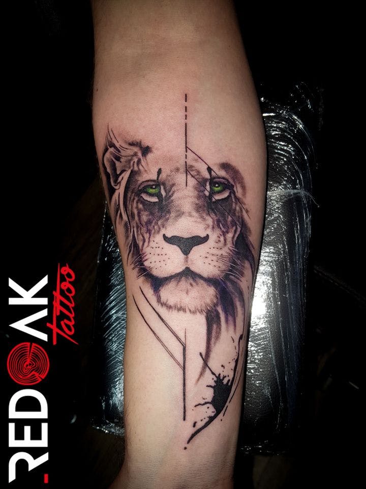 a cover-up tattoo of a lion with a bow, viersen, germany