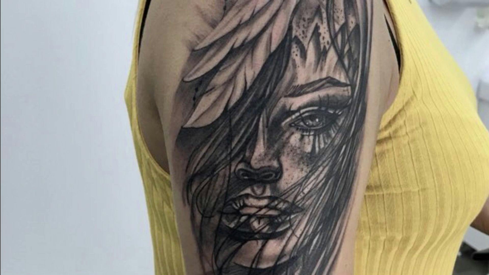 a woman with a black and white cover-up tattoo on her arm, wetteraukreis, germany