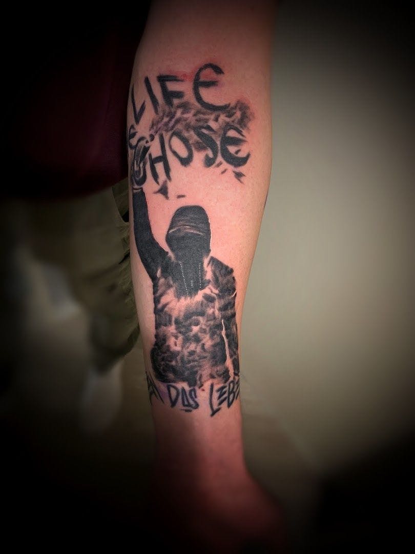a cover-up tattoo with a black and white image of a man holding a sword, oldenburg, germany