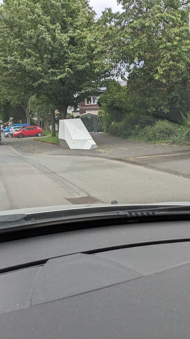 a car driving down a street with a ramp