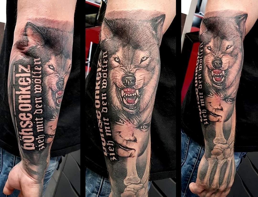 a wolf cover-up tattoo on the arm, rostock, germany