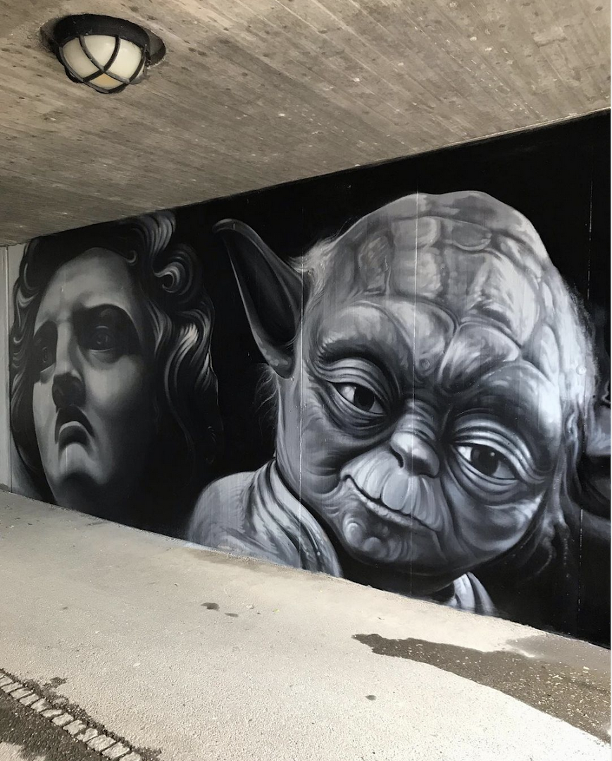 a mural of two faces and a face of a man