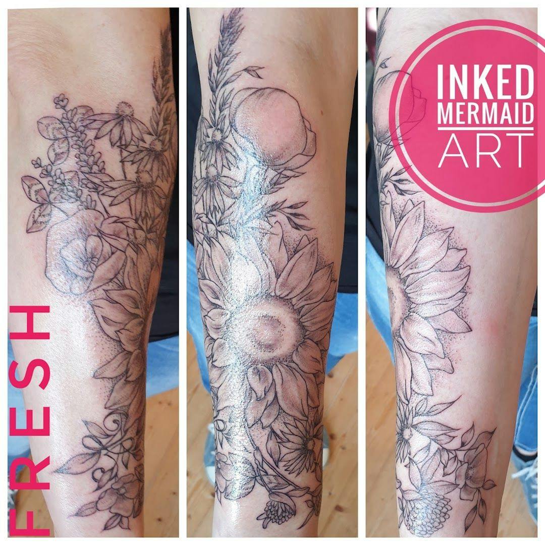 a narben tattoo artist's arm with flowers and leaves, aurich, germany