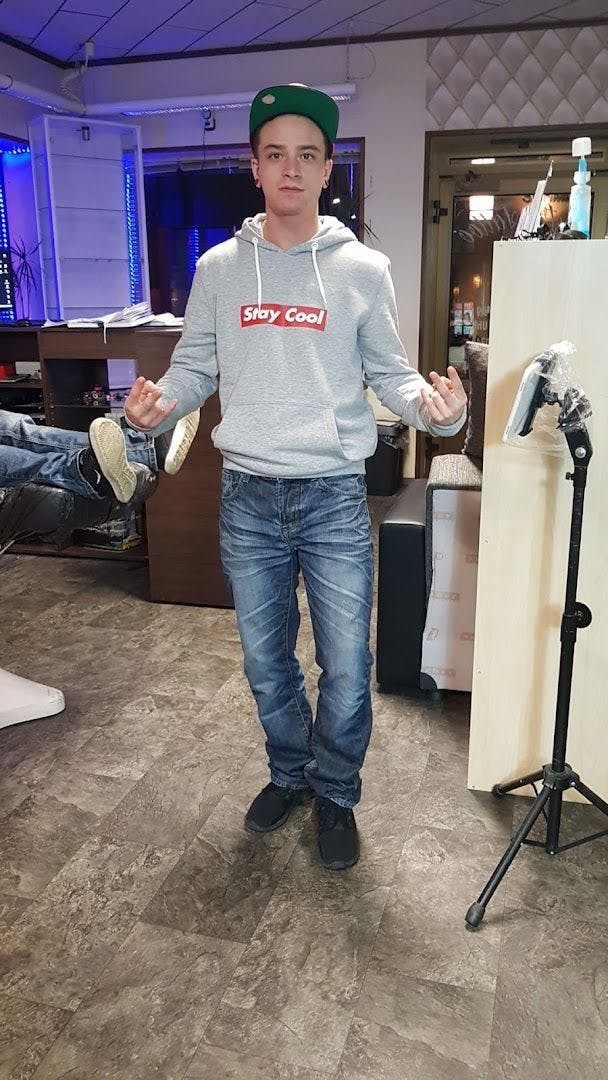 a man in a grey sweatshirt and jeans
