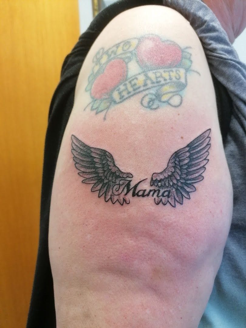 a narben tattoo with a heart and wings on the arm, kreisfreie stadt bottrop, germany
