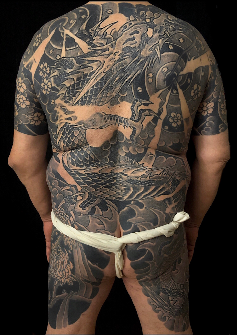 a man with a japanische tattoos in leipzig on his back, düsseldorf, germany