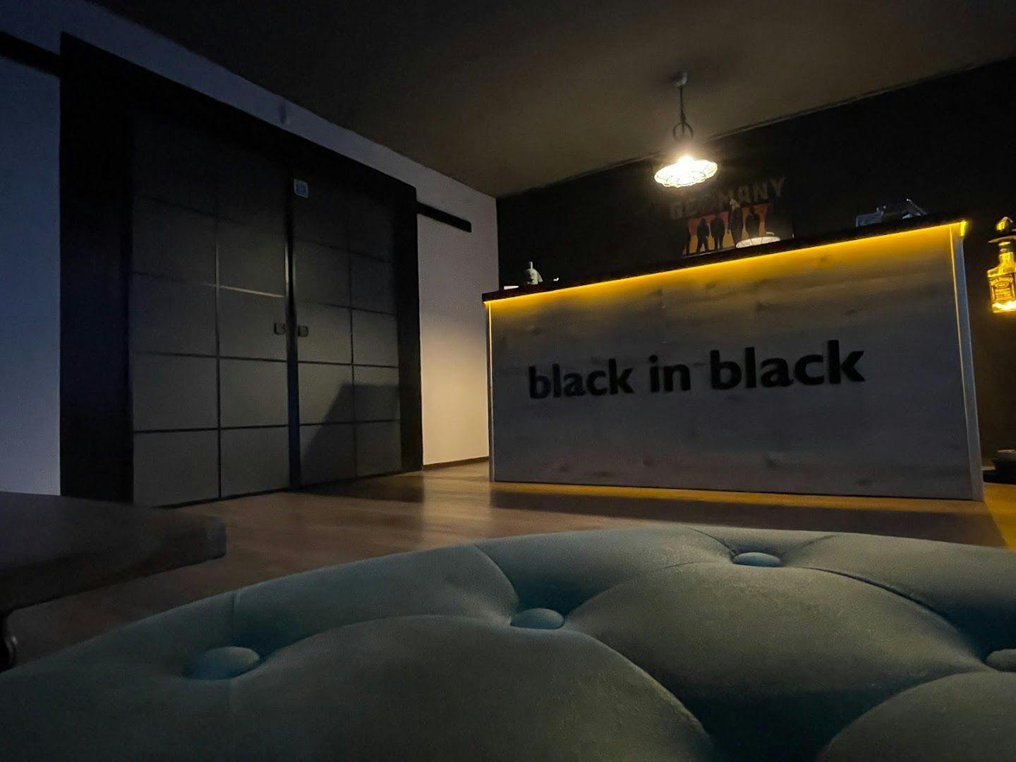 a black and white reception area with a neon sign