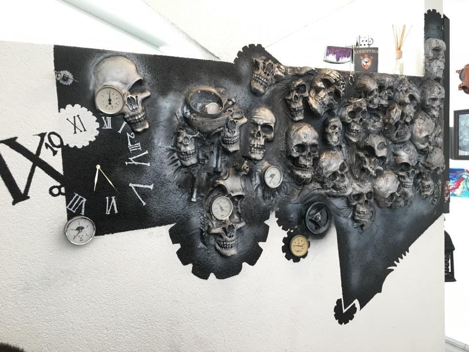 a wall with skulls and a clock