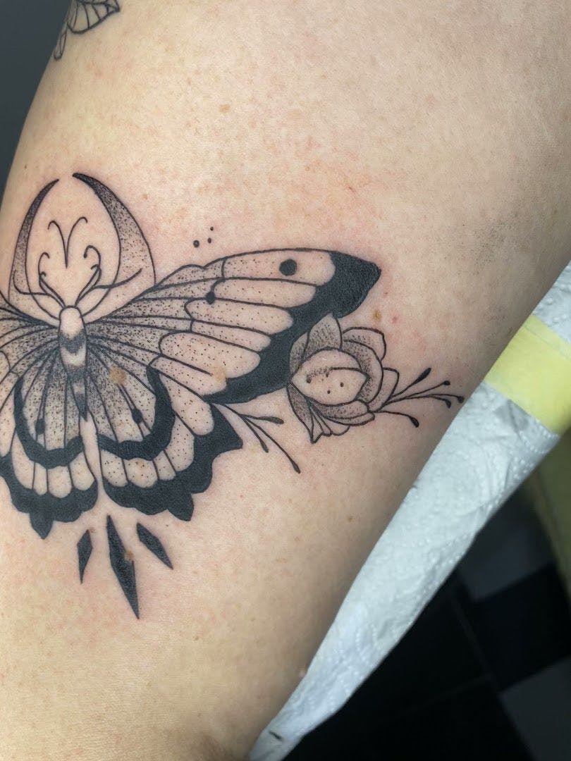a black and white butterfly narben tattoo on the arm, minden-lübbecke, germany