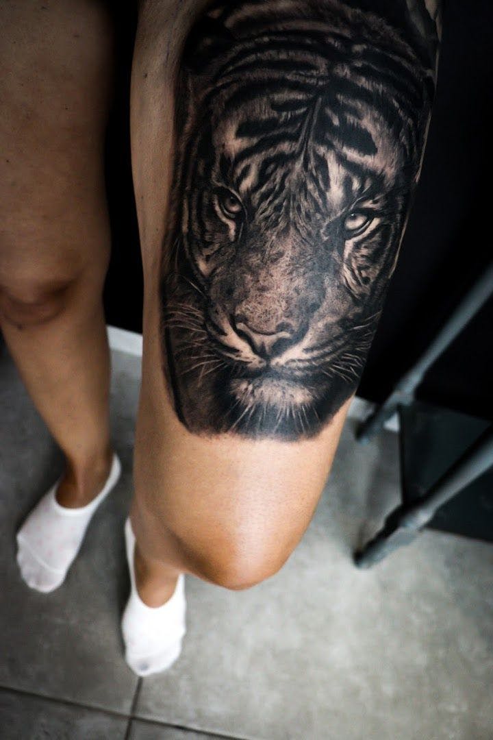 a black and white tiger cover-up tattoo on the leg, dresden, germany