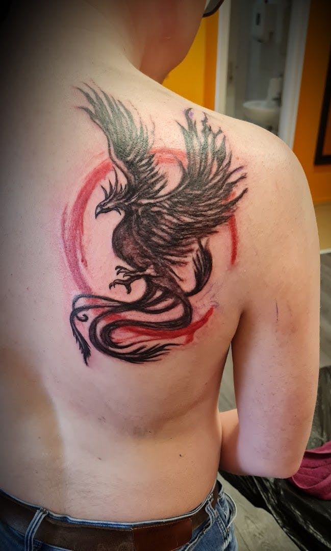 a narben tattoo design of a dragon on the back of a man, hamburg, germany