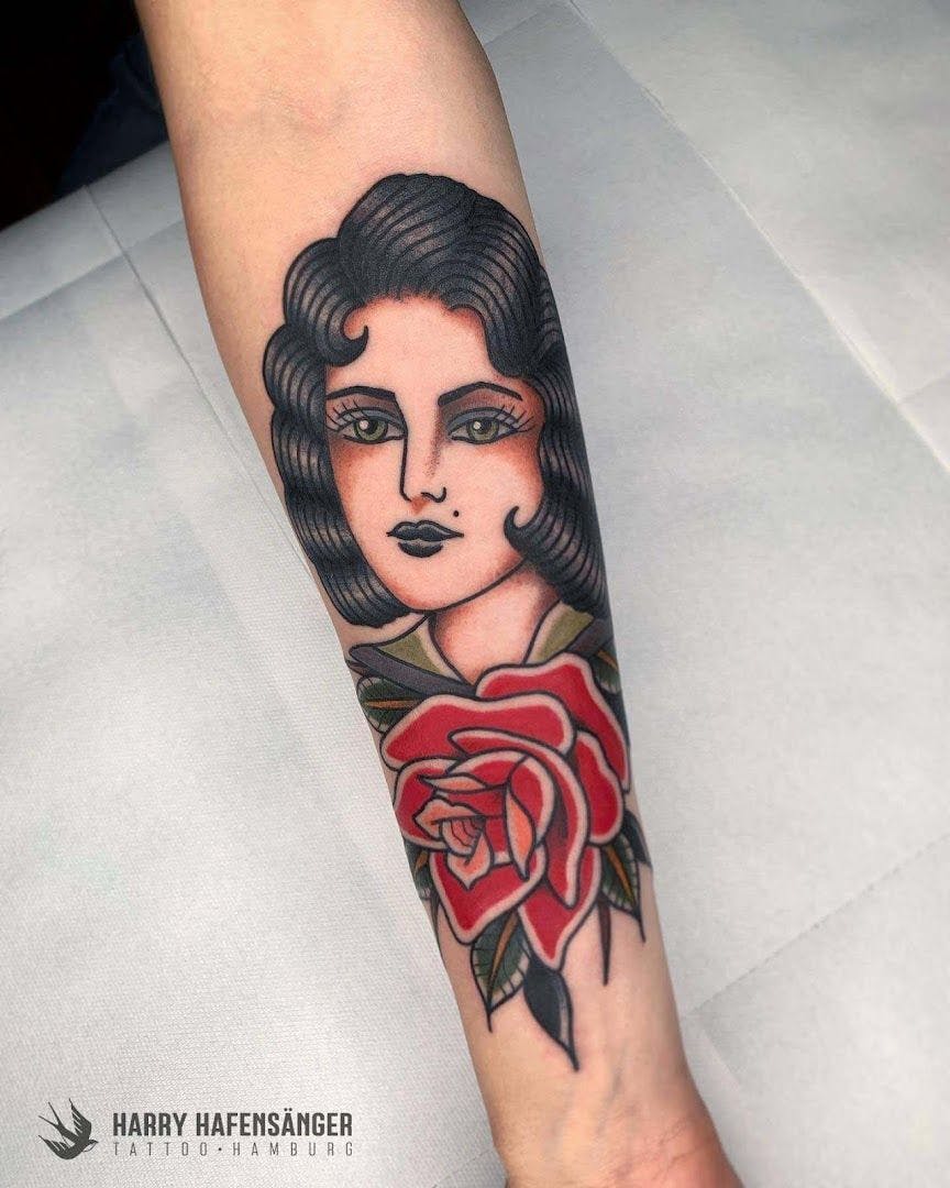 a narben tattoo of a woman with a rose on her arm, hamburg, germany