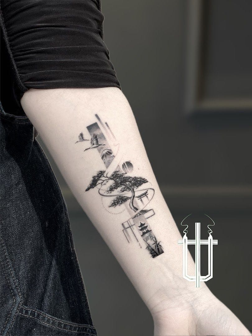 a man's arm with a small cover-up tattoo of a lighthouse and a tree, berlin, germany