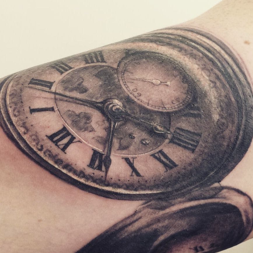 a clock cover-up tattoo on the arm, berlin, germany
