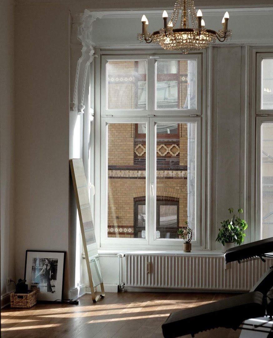 a room with a piano and a window