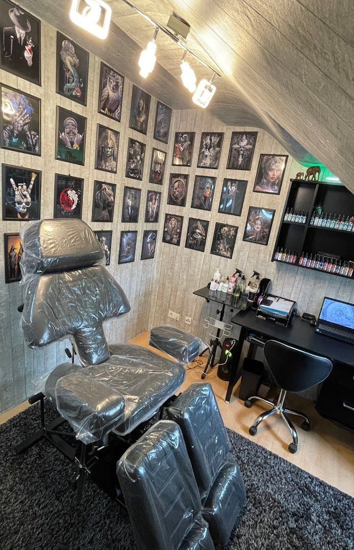 a room with a chair and pictures on the wall