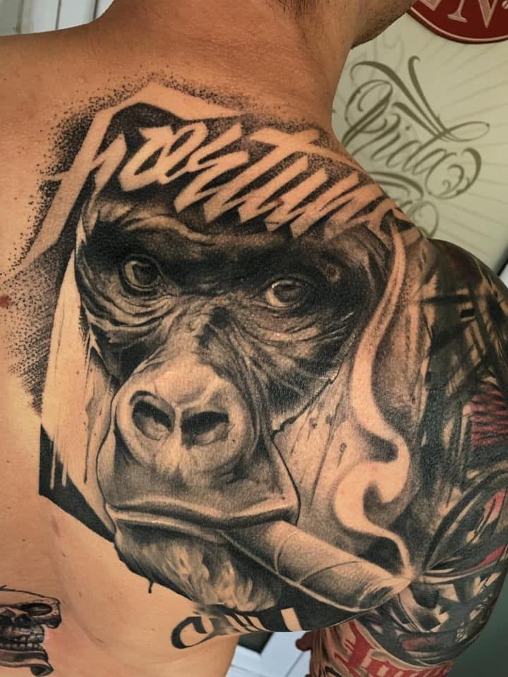 a cover-up tattoo of a gorilla on the back, hamburg, germany