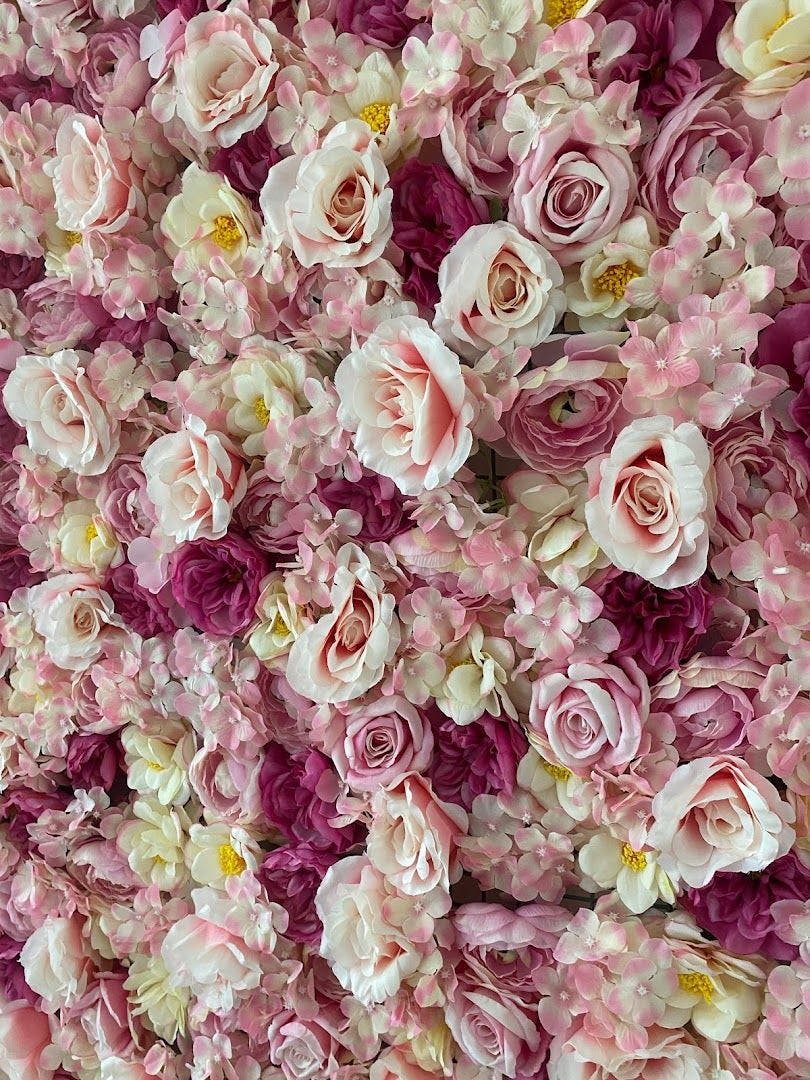 a large pile of pink and white flowers