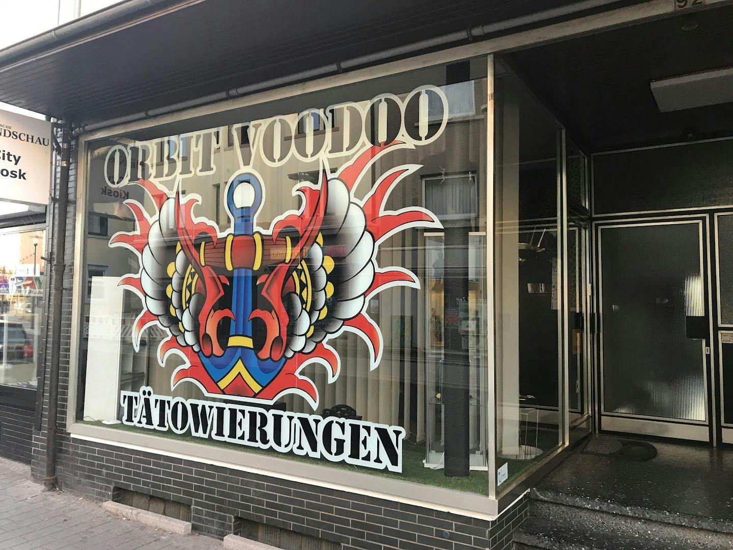 a store front with a large window with a cover-up tattoo design, ennepe-ruhr-kreis, germany
