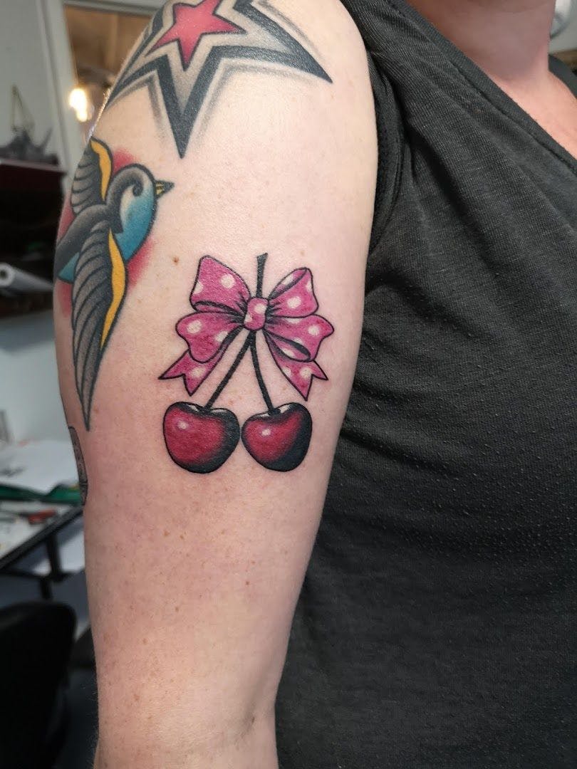 a narben tattoo with a bow and a cherry, hamburg, germany